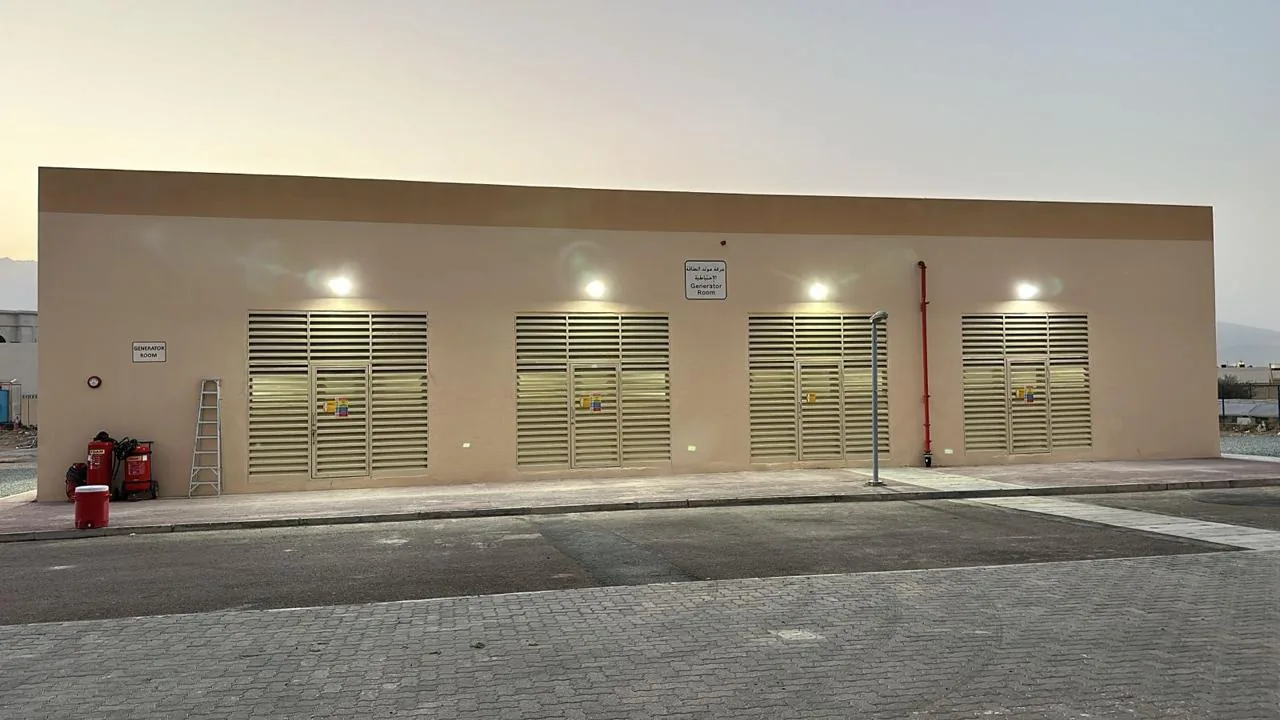 Louvred generator building at dusk